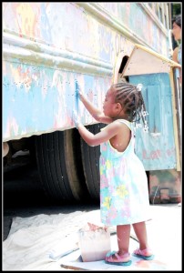 child painting on art bus